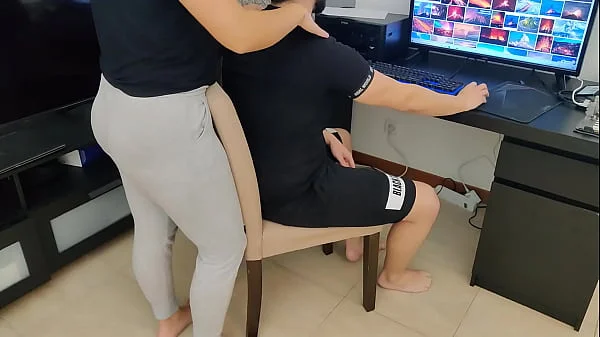 mature gives her stepson a handjob while watching porn