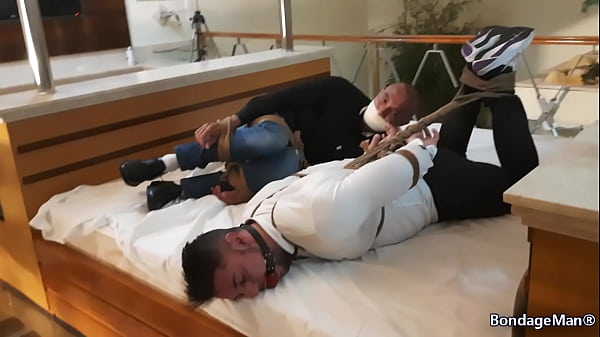 Peter and Victor tied up together on the bed ballgagged and gagged struggling | PREVIEW